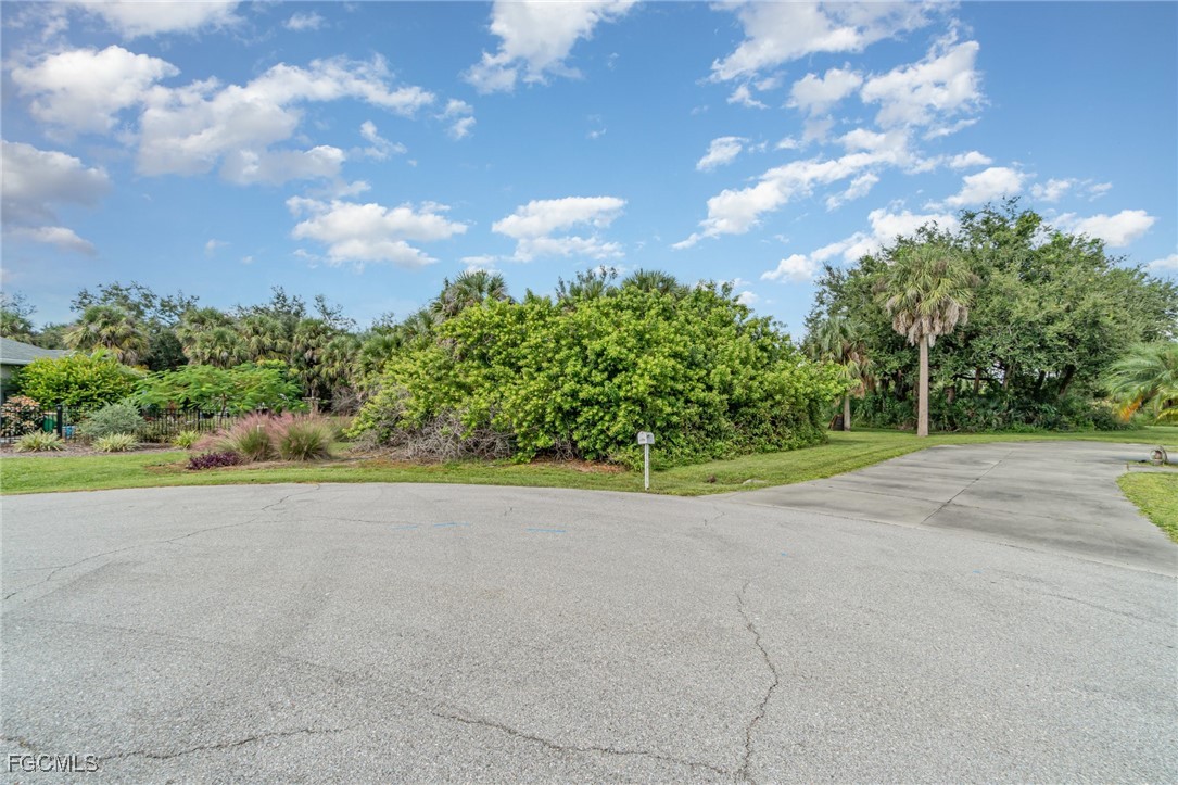 254 Spring Drive Rotonda West, FL 33947 - Photo 2 of 13 a view of a garden with a building