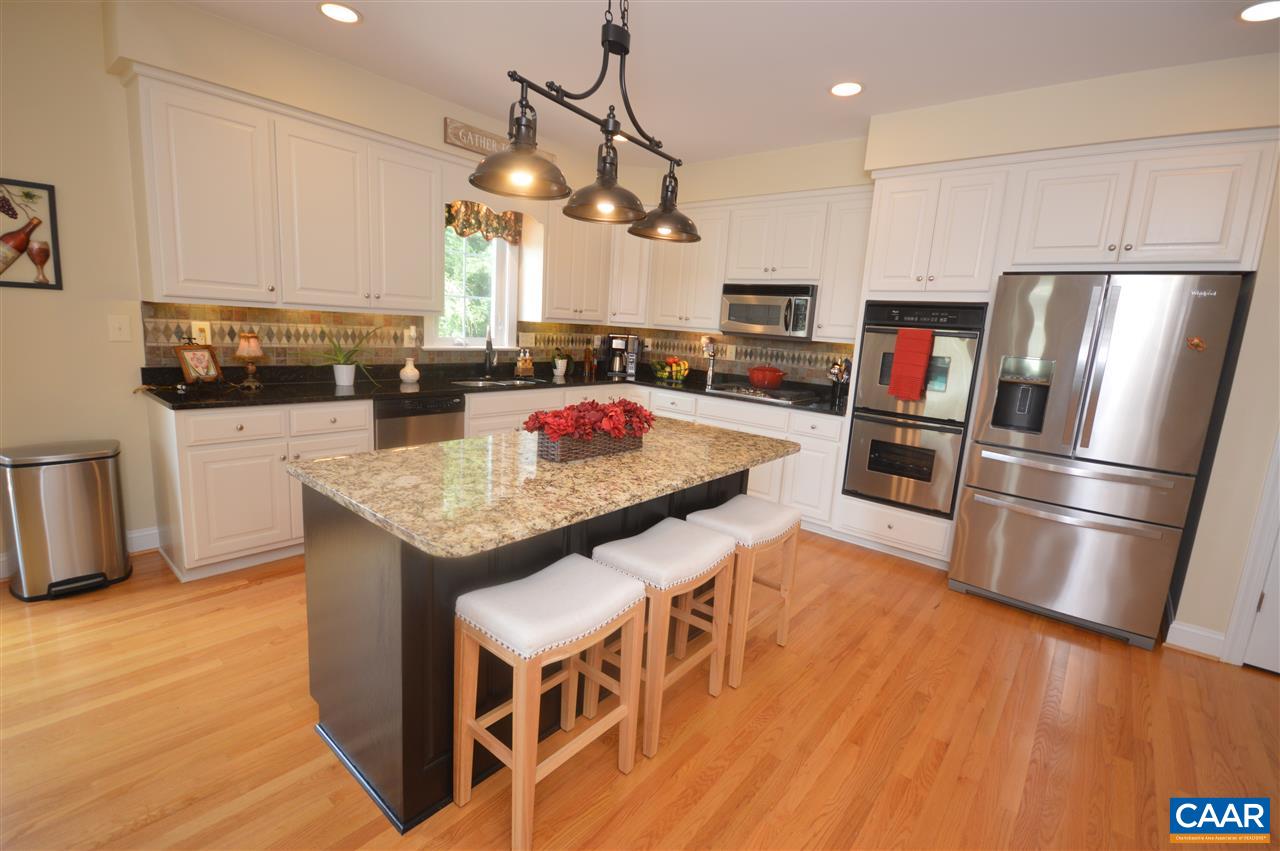 401 Sam Durrer Road Ruckersville, VA 22968 - Photo 15 of 50 a kitchen with granite countertop stainless steel appliances a refrigerator a stove a sink dishwasher and white cabinets with wooden floor