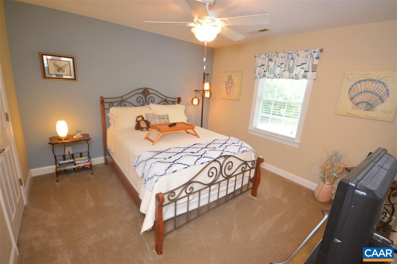 401 Sam Durrer Road Ruckersville, VA 22968 - Photo 17 of 50 a bedroom with a bed and a chandelier