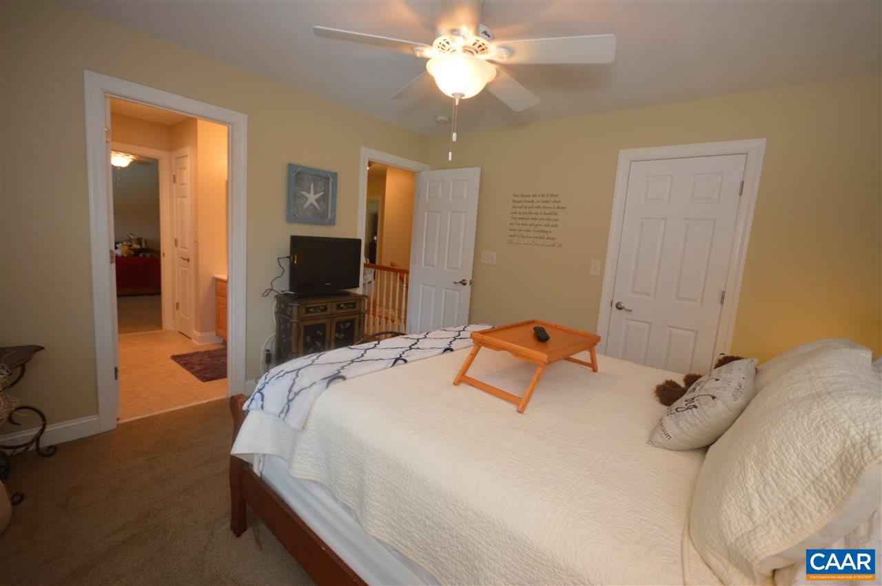 401 Sam Durrer Road Ruckersville, VA 22968 - Photo 18 of 50 a bedroom with a bed and a flat tv screen on dresser