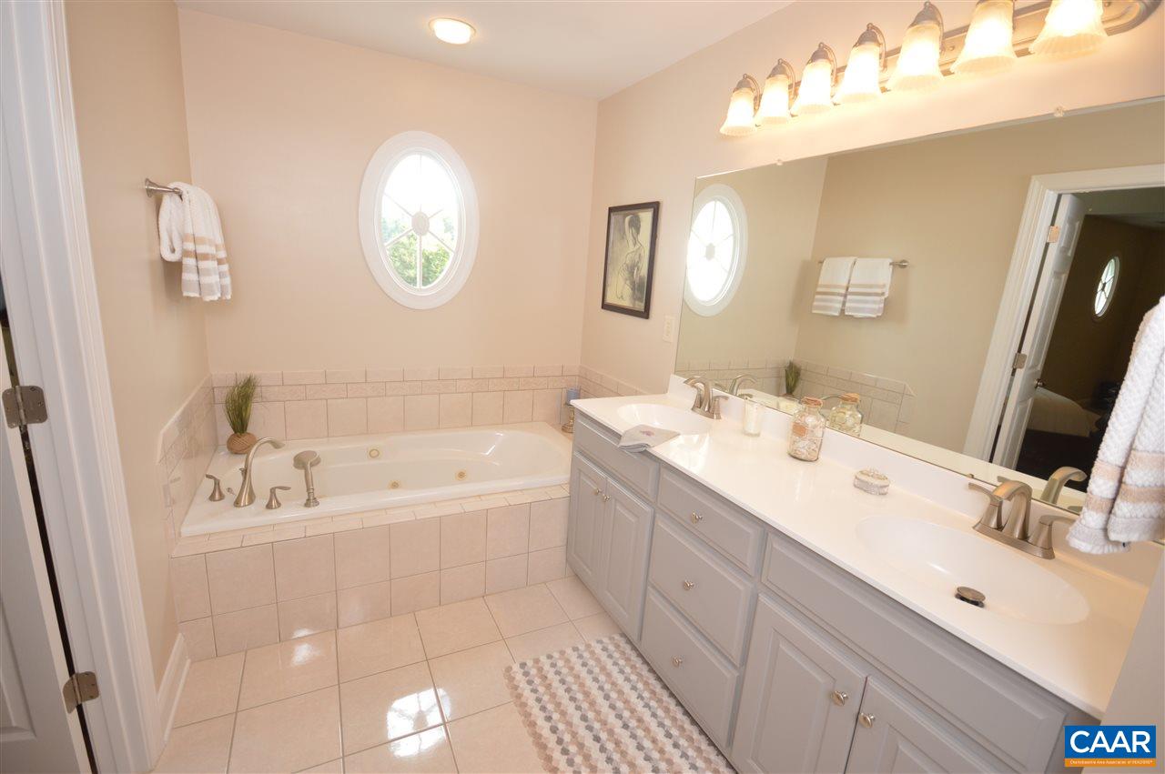 401 Sam Durrer Road Ruckersville, VA 22968 - Photo 28 of 50 a spacious bathroom with a double vanity sink a mirror and a bathtub