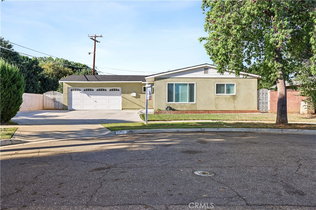4106 Goodman Street Riverside, CA 92503 - Photo 1 of 20 a front view of a house with a garden and yard