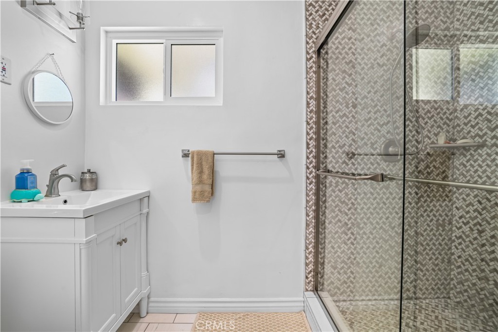 4106 Goodman Street Riverside, CA 92503 - Photo 11 of 20 a bathroom with a sink a mirror and shower