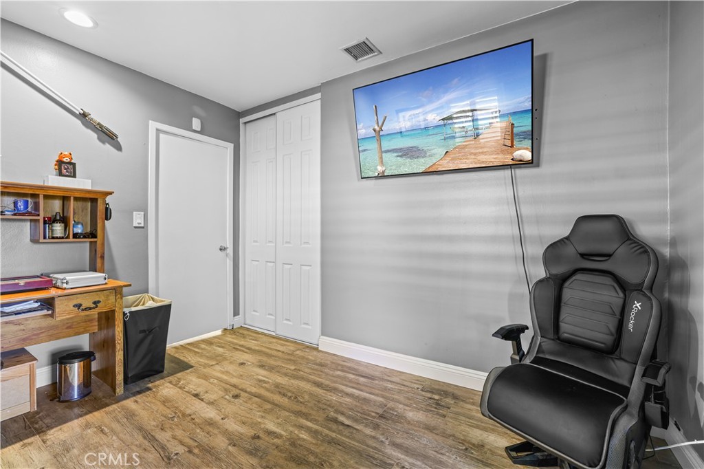 4106 Goodman Street Riverside, CA 92503 - Photo 13 of 20 a bedroom with a bed and a bookshelf