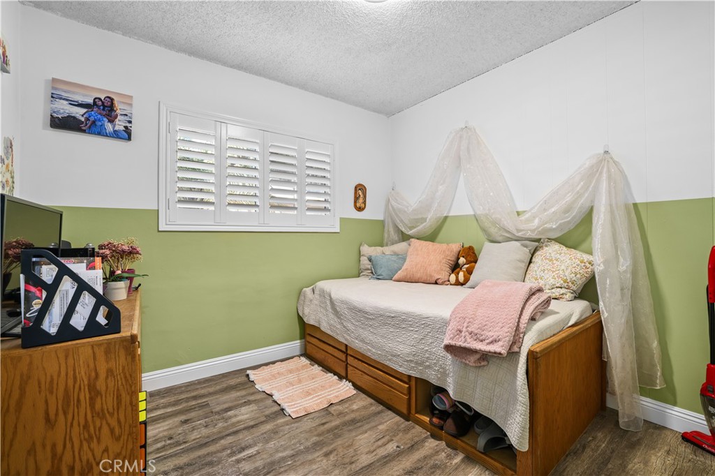 4106 Goodman Street Riverside, CA 92503 - Photo 14 of 20 a bed room with a bed and a painting on the wall