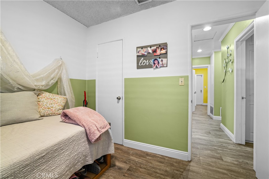 4106 Goodman Street Riverside, CA 92503 - Photo 15 of 20 a bedroom with a bed and a mirror