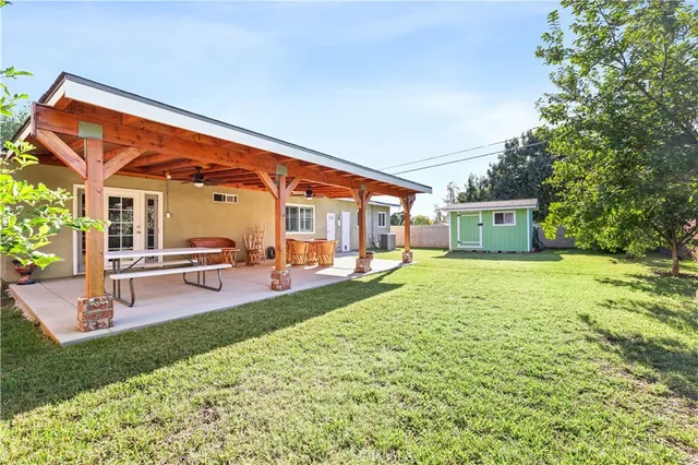 a backyard of a house with table and chairs