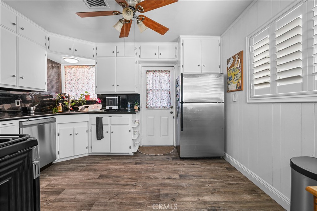 4106 Goodman Street Riverside, CA 92503 - Photo 7 of 20 a kitchen with stainless steel appliances a refrigerator sink and cabinets