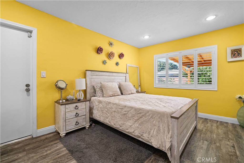 4106 Goodman Street Riverside, CA 92503 - Photo 9 of 20 a bedroom with a bed and wooden floor