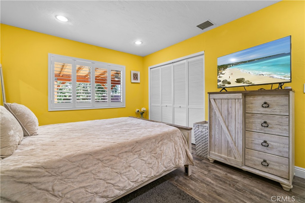 4106 Goodman Street Riverside, CA 92503 - Photo 10 of 20 a bedroom with a bed and wooden floor