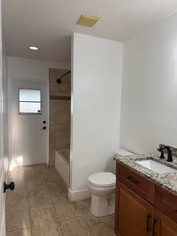 a view of an empty room with a fan