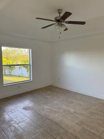 a bathroom with a granite countertop sink and a toilet