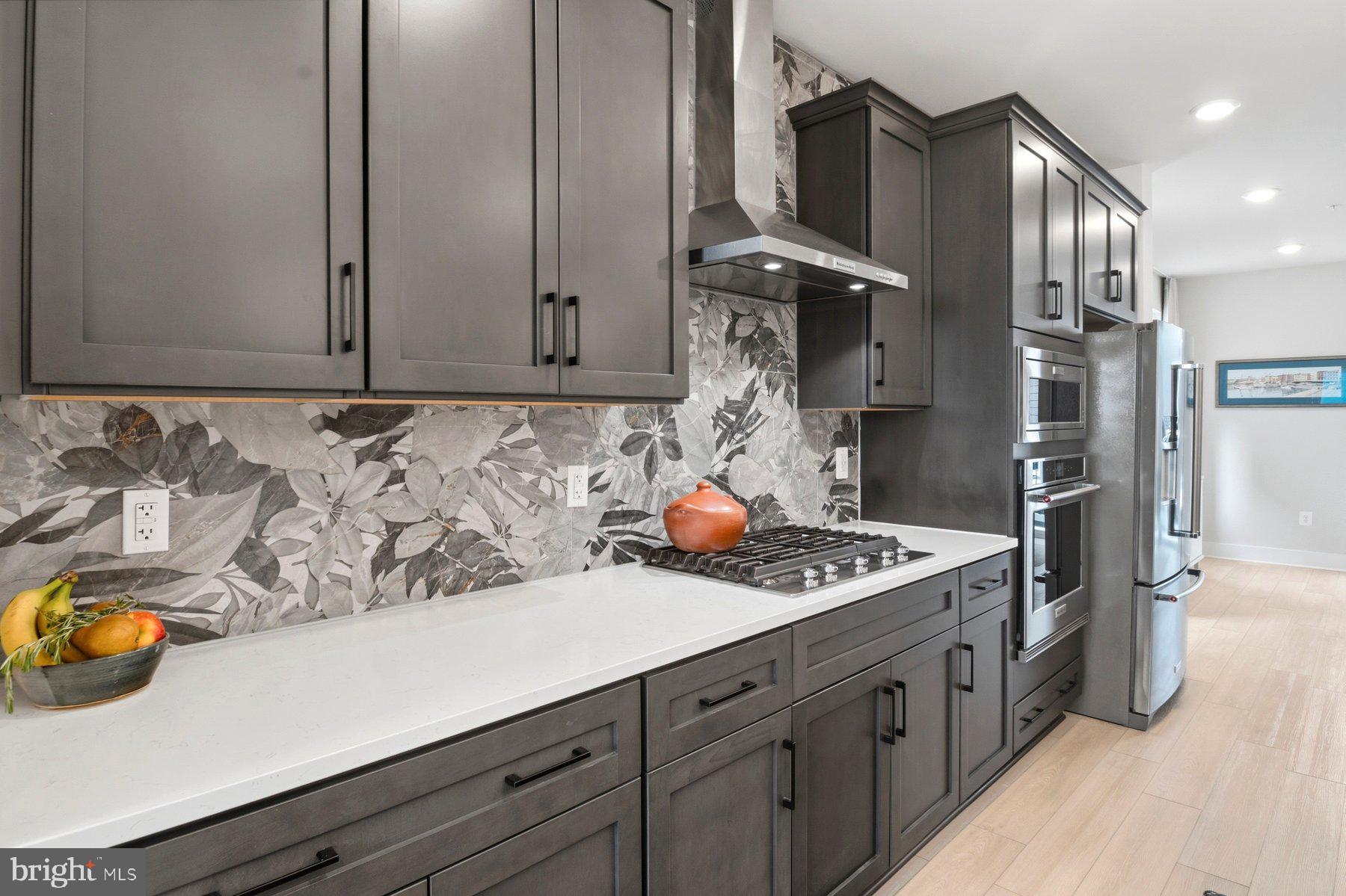 100 Glass Lane Baltimore, MD 21230 - Photo 15 of 36 a kitchen with stainless steel appliances granite countertop a sink a stove and a refrigerator