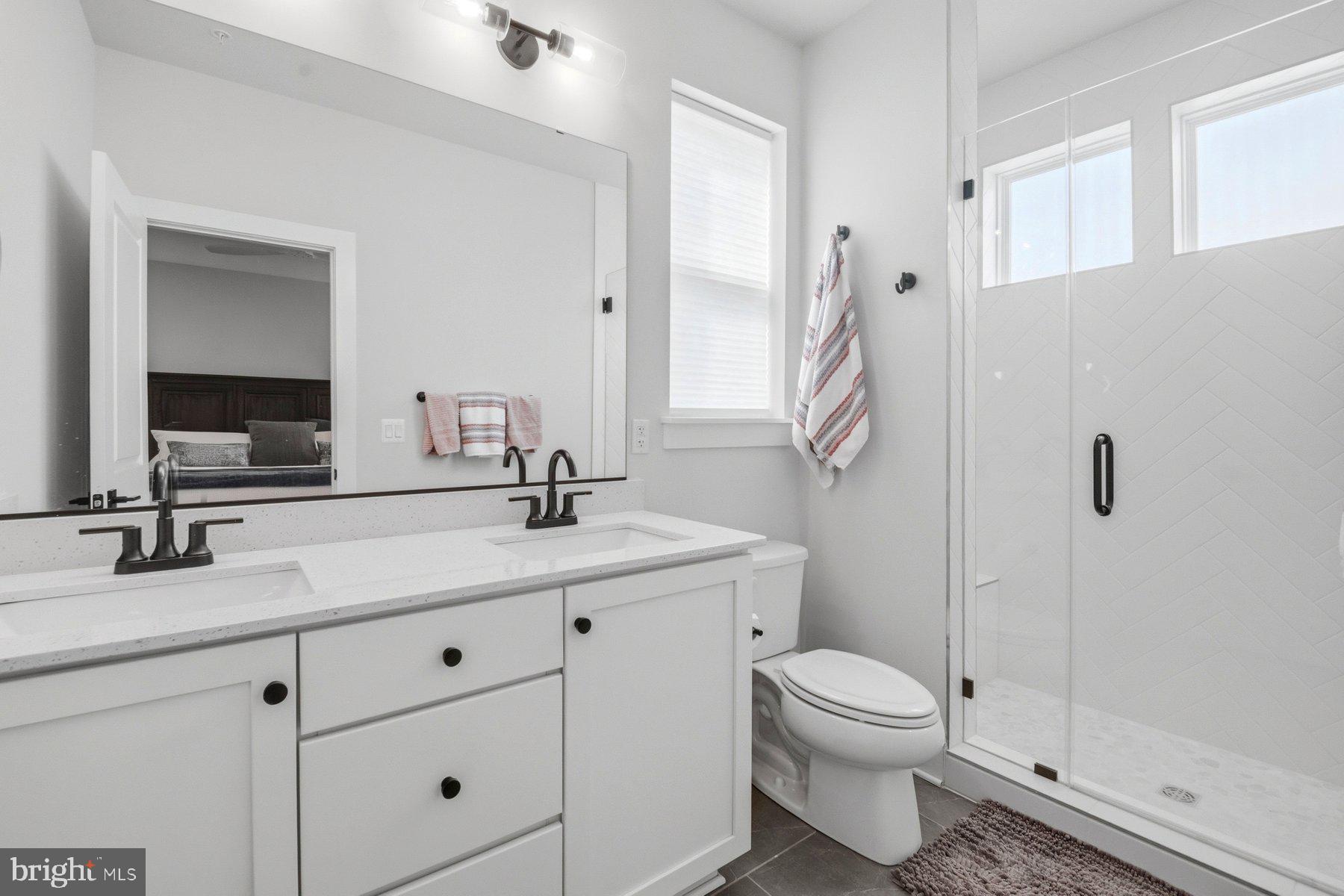 100 Glass Lane Baltimore, MD 21230 - Photo 24 of 36 a bathroom with a double vanity sink toilet and shower