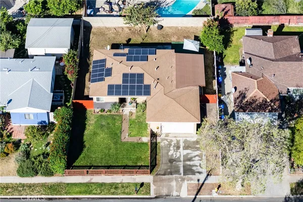 an aerial view of residential houses with outdoor space and street view