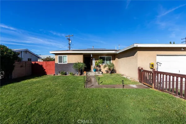 a view of a house with backyard and porch
