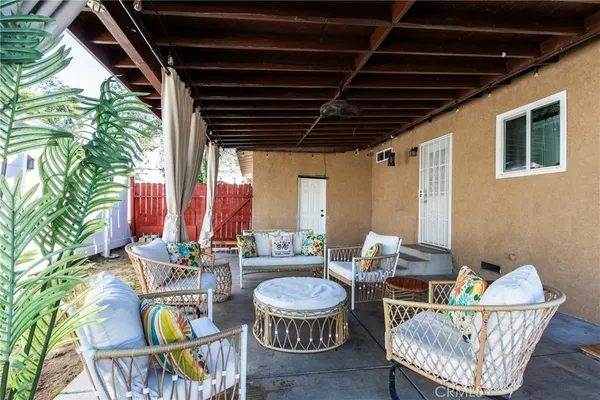 a view of a chair and tables in the patio