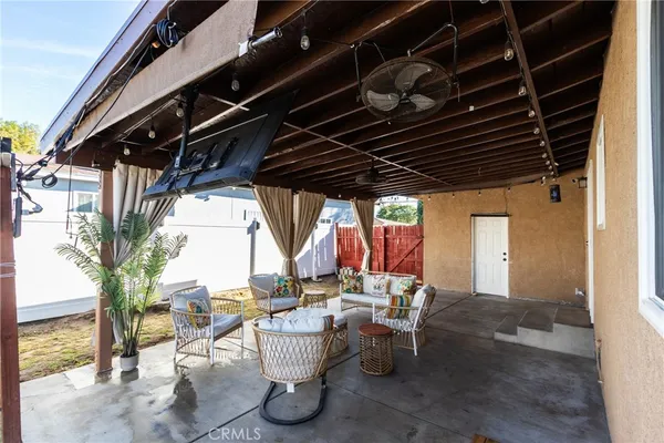 a view of a house with wooden deck and furniture