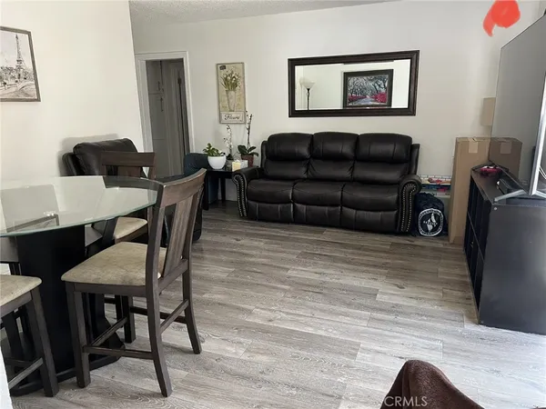a living room with furniture and a computer on the desk