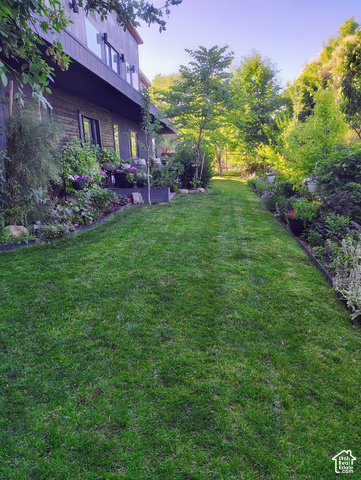 1397 Ritter Drive Riverdale, UT 84405 - Photo 16 of 21 Expansive manicured lawn bordered by lush landscaping and mature trees
