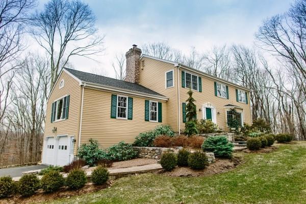 a front view of a house with a yard and potted plants