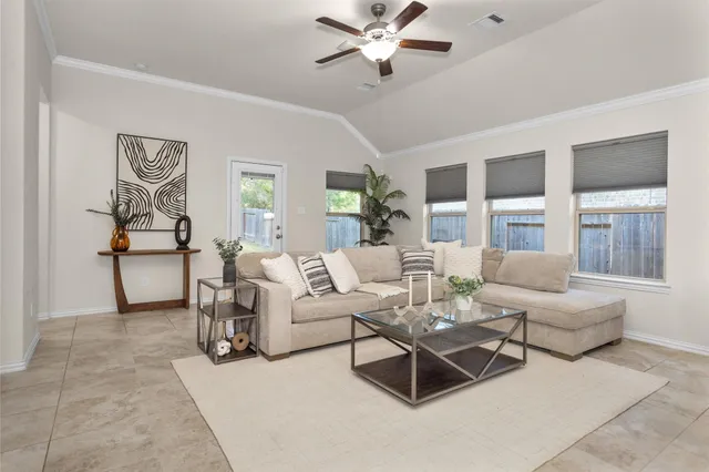 a living room with furniture and a large window