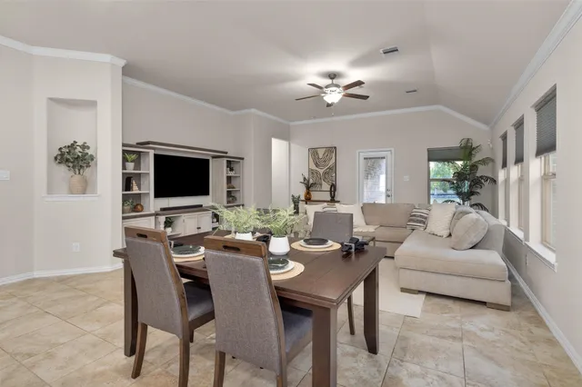 a living room with furniture a chandelier and a flat screen tv