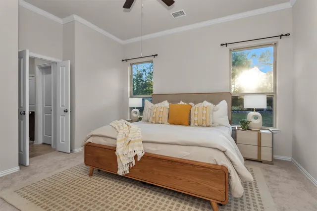 a bedroom with a bed and a window