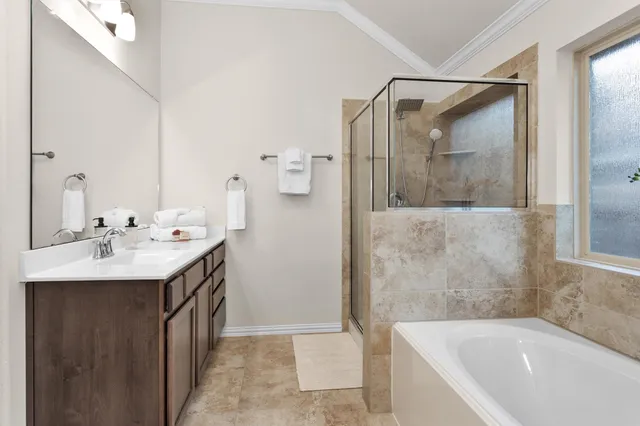 a bathroom with a tub sink and mirror