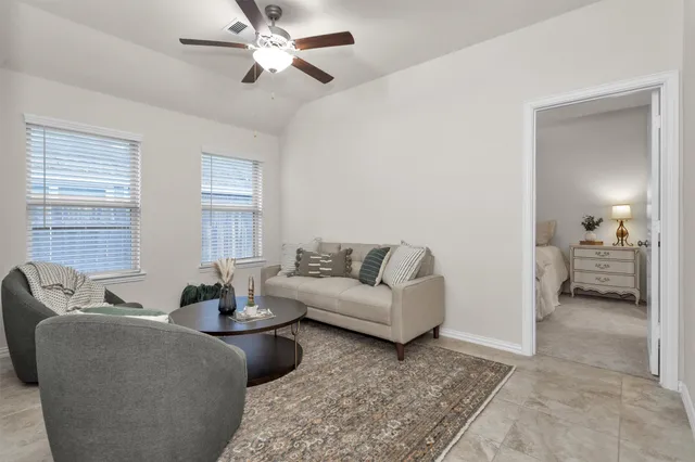 a living room with furniture and a large window