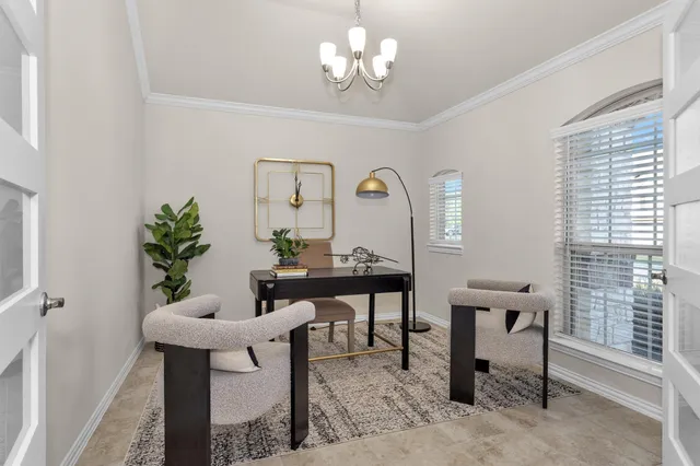 a view of a dining room with furniture and a chandelier