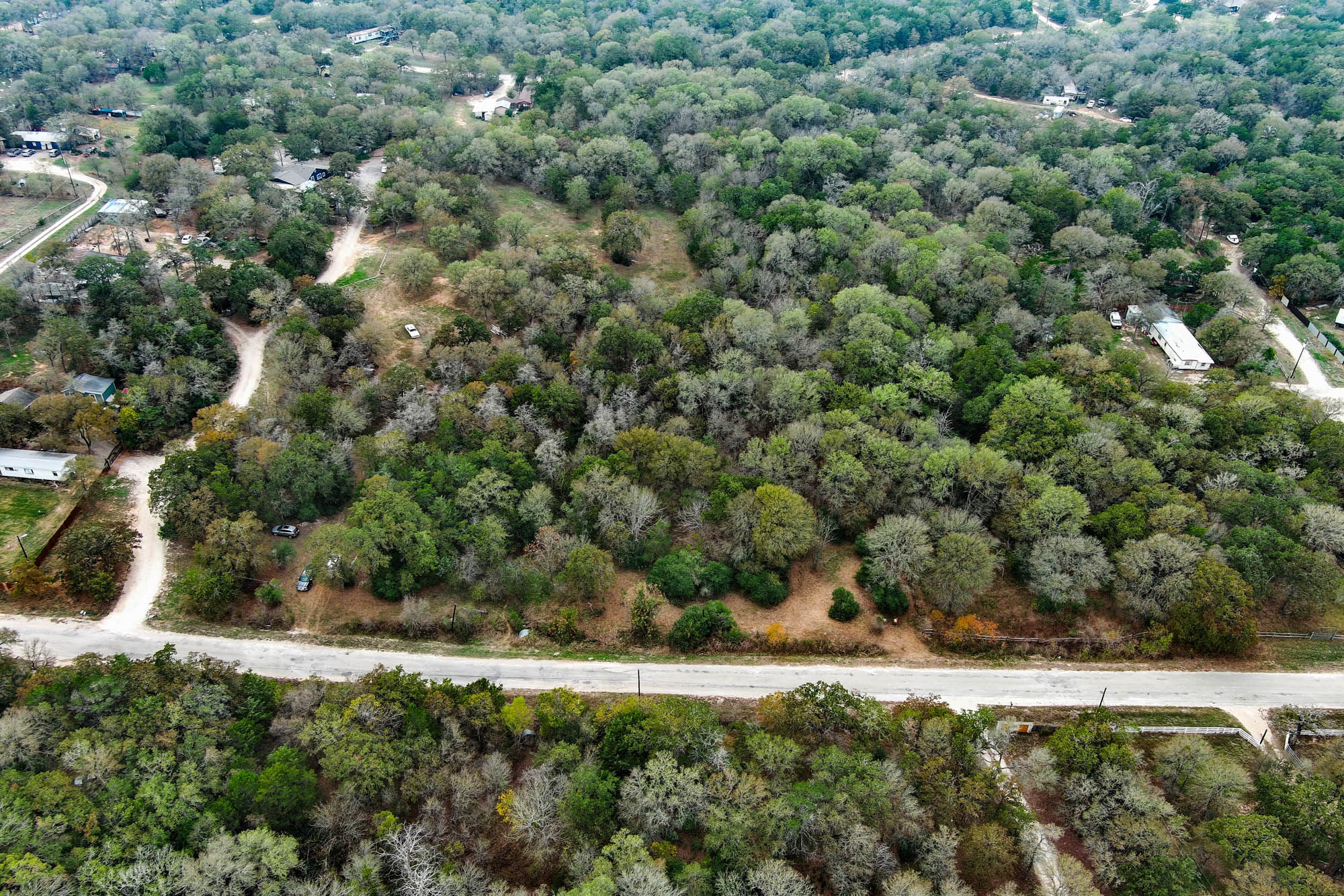 233 The Forest Road Dale, TX 78616 - Photo 13 of 15 Aerial view of property's location featuring a heavily wooded area
