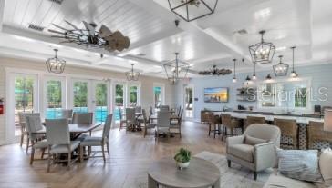35 Birdie Way Bunnell, FL 32110 - Photo 57 of 57 a dining room with wooden floor a chandelier a glass table and chairs