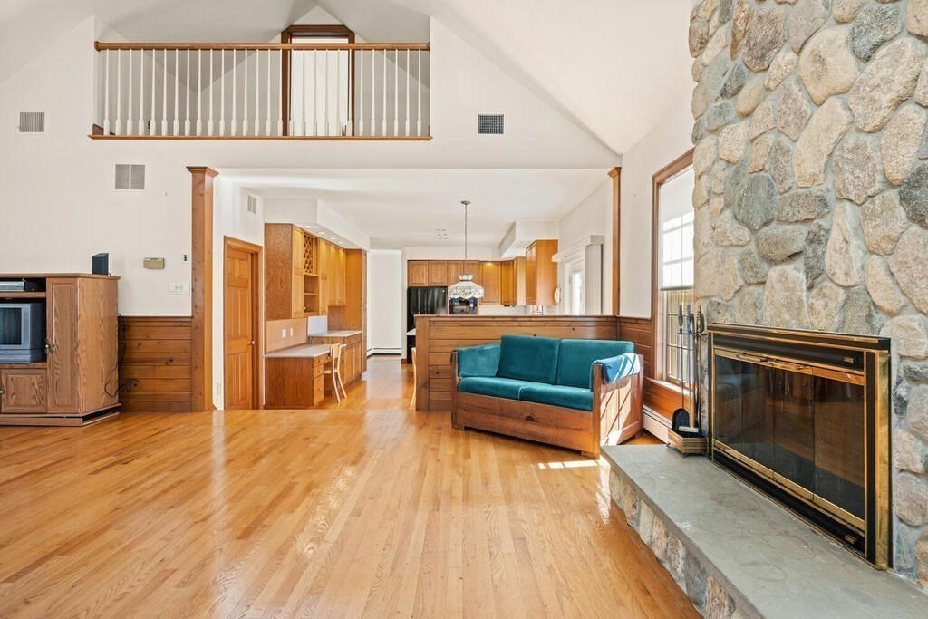 3 Royal Circle Lexington, MA 02420 - Photo 13 of 42 a living room with stainless steel appliances furniture a fireplace and a flat screen tv