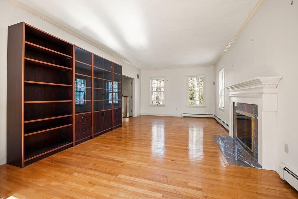 3 Royal Circle Lexington, MA 02420 - Photo 17 of 42 a view of empty room with wooden floor and fireplace