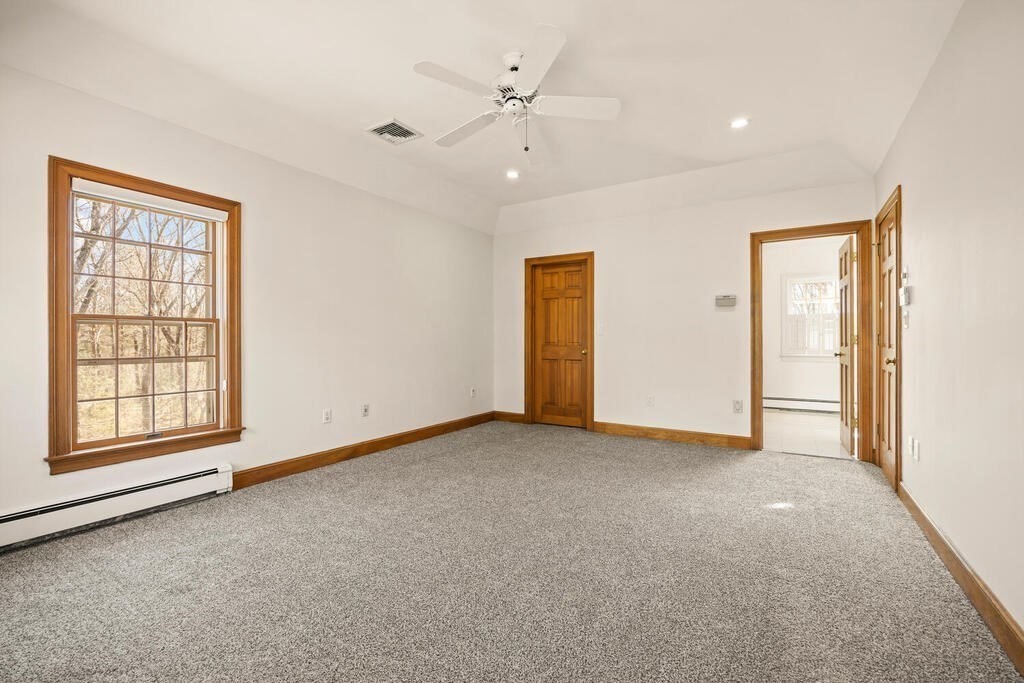 3 Royal Circle Lexington, MA 02420 - Photo 24 of 42 an empty room with windows and ceiling fan