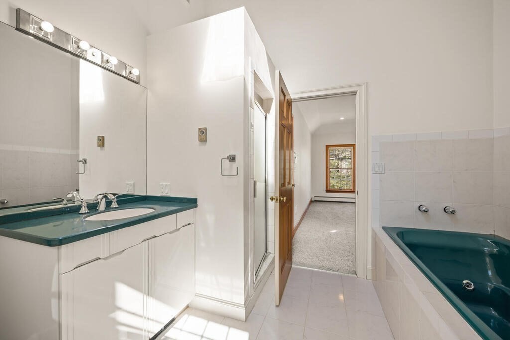 3 Royal Circle Lexington, MA 02420 - Photo 28 of 42 a bathroom with a granite countertop sink and a mirror