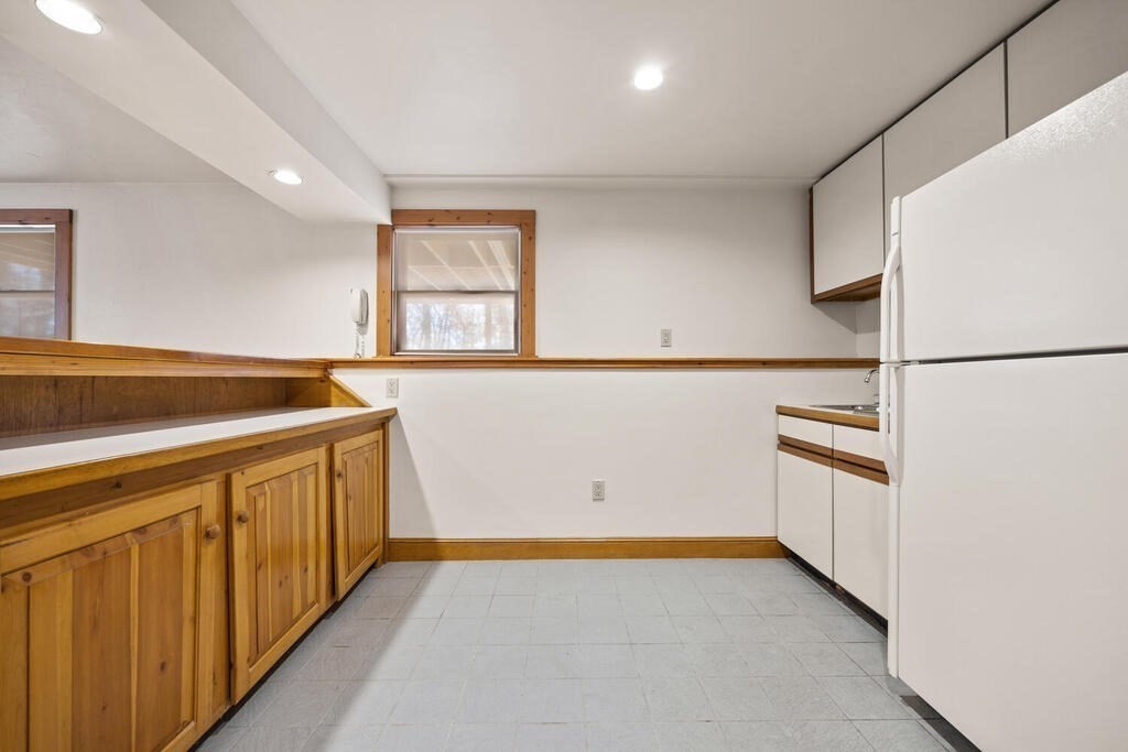 3 Royal Circle Lexington, MA 02420 - Photo 31 of 42 a kitchen with granite countertop white cabinets and white appliances