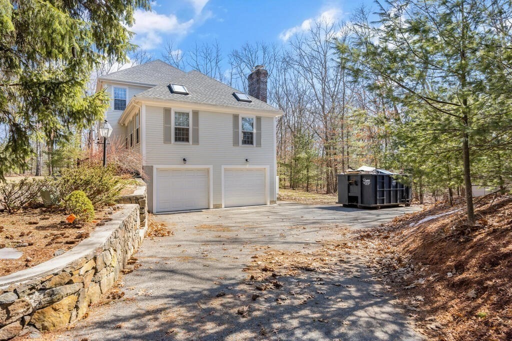 3 Royal Circle Lexington, MA 02420 - Photo 38 of 42 a front view of a house with a yard and garage