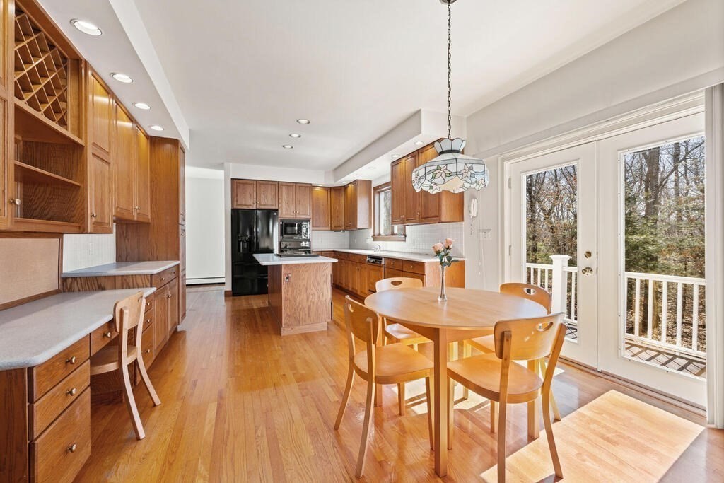 3 Royal Circle Lexington, MA 02420 - Photo 5 of 42 a view of a dining room and livingroom with furniture wooden floor a chandelier