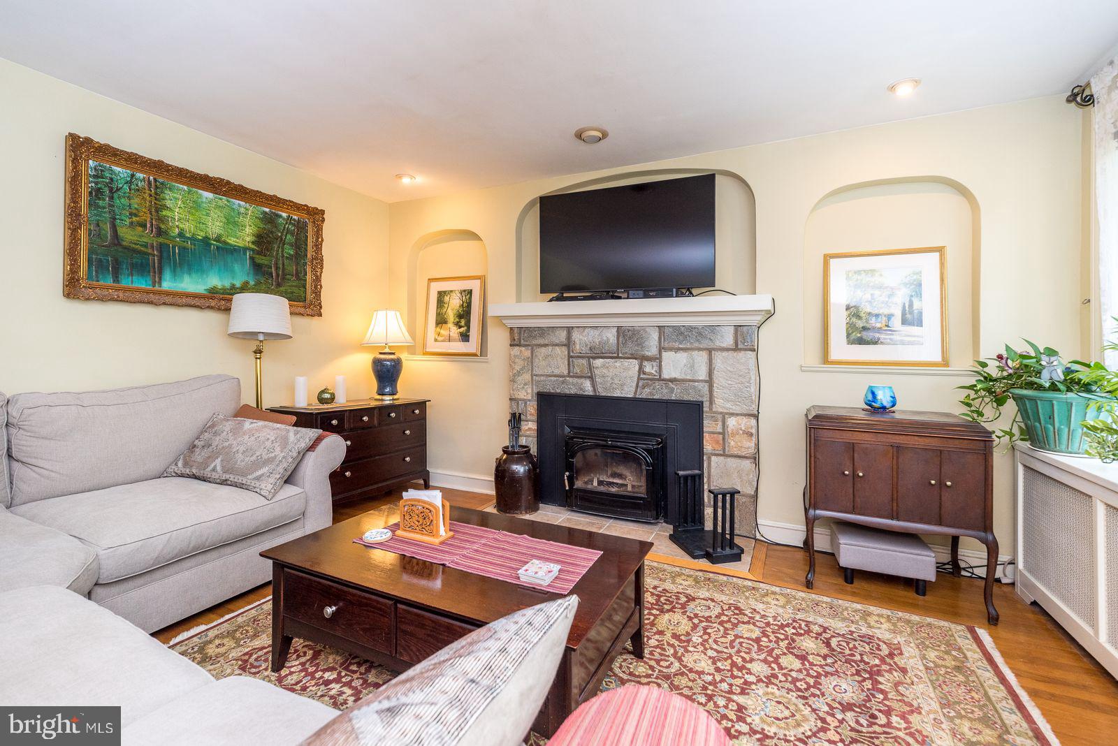 534 Pinney Road Huntingdon Valley, PA 19006 - Photo 5 of 26 a living room with furniture a flat screen tv and a fireplace