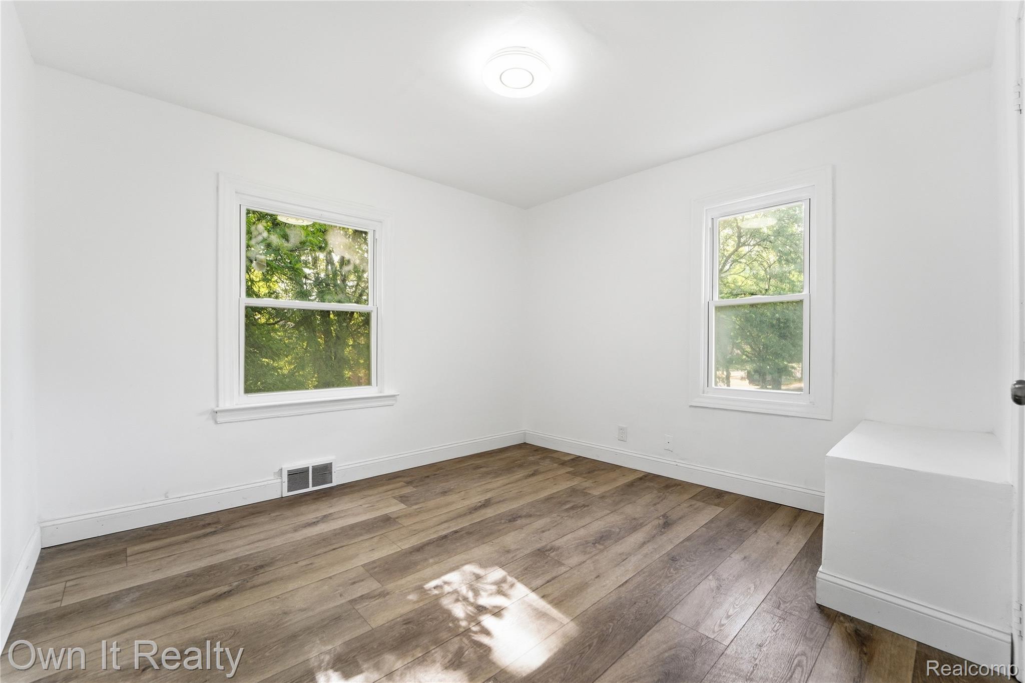 17351 Appoline Street Detroit, MI 48235 - Photo 25 of 34 Bright interior space featuring wood-finish flooring, white trim, and two windows