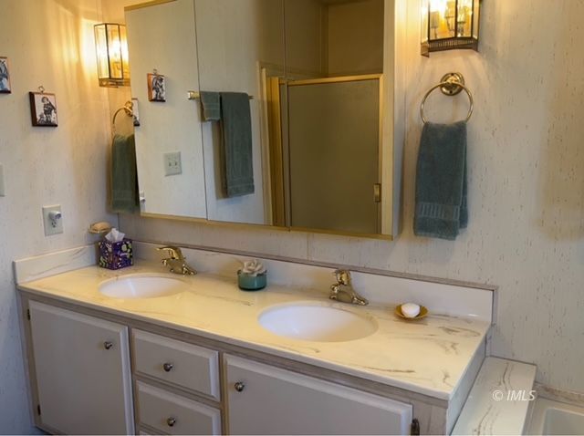 2263 Darby Avenue Bishop, CA 93514 - Photo 19 of 23 a bathroom with a granite countertop sink and a mirror