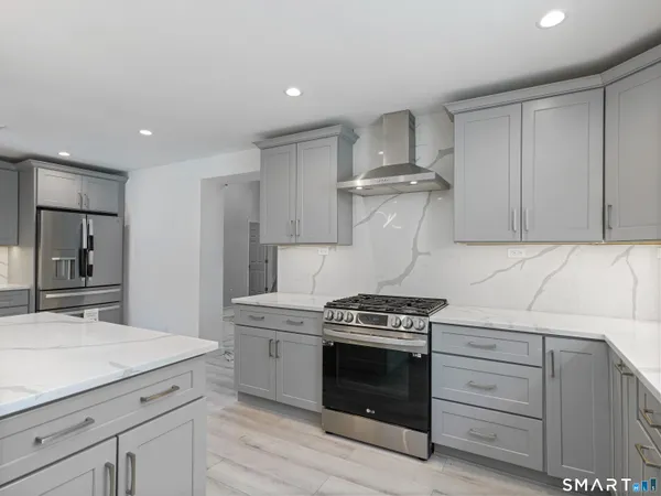 a kitchen with a stove and white cabinets