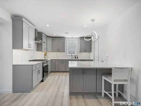 a kitchen with a sink cabinets and wooden floor