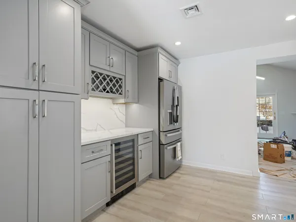 a kitchen with stainless steel appliances a refrigerator sink and cabinets