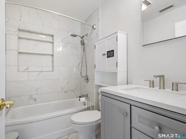 a bathroom with a sink toilet and shower