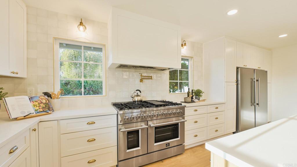 1520 Via Rancho Parkway Escondido, CA 92029 - Photo 39 of 89 a kitchen with stainless steel appliances a stove a sink and a refrigerator
