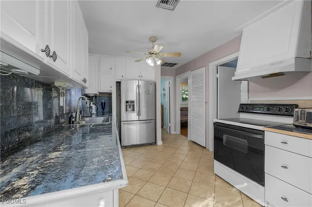 a kitchen with a refrigerator a sink and a stove