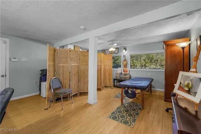 a living room with furniture a piano and a window
